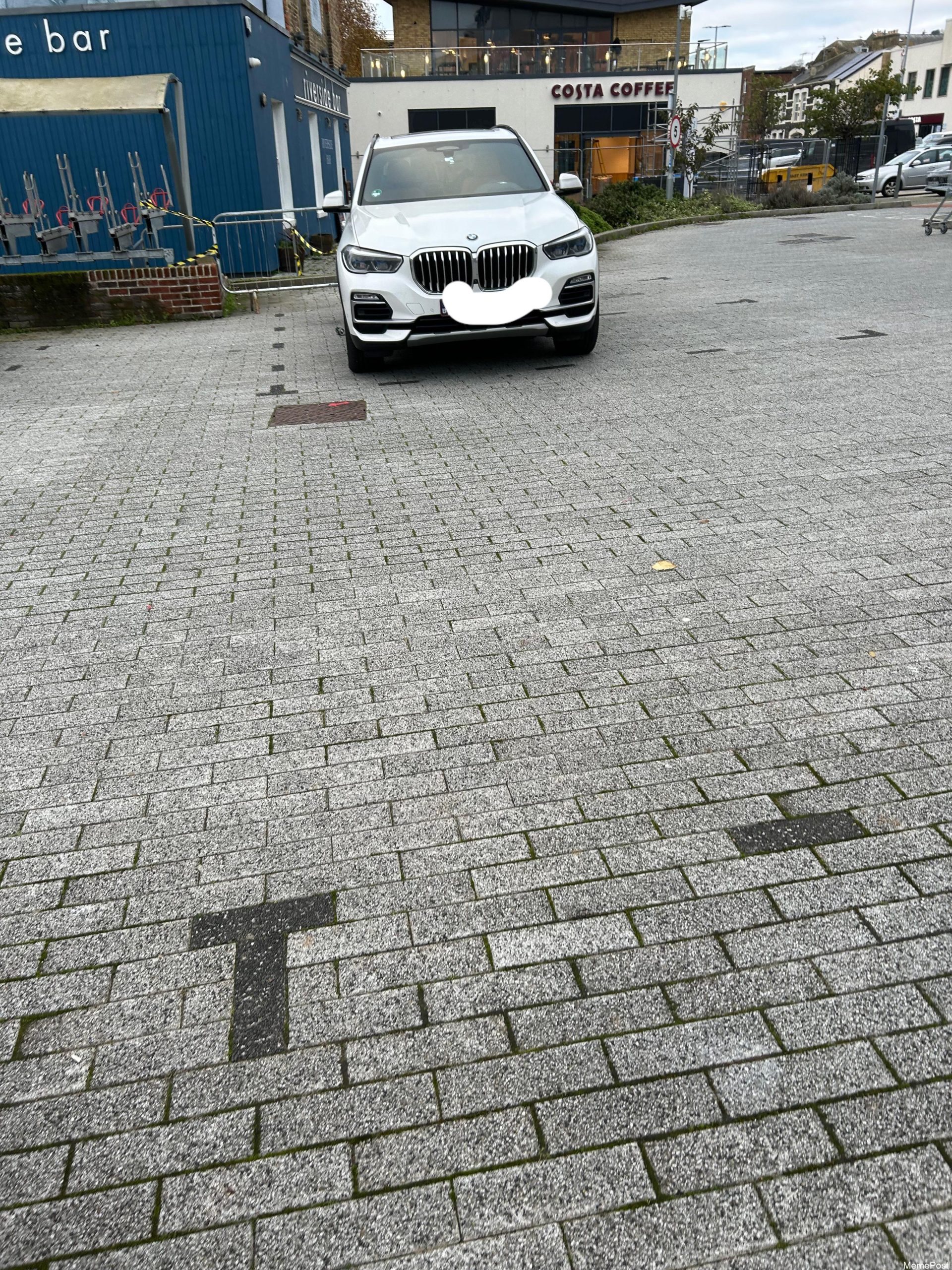 Crappy Bay Markings: Car Stuck in 3 Bays—UK Parking Nightmare Made Worse in Rainy Weather!